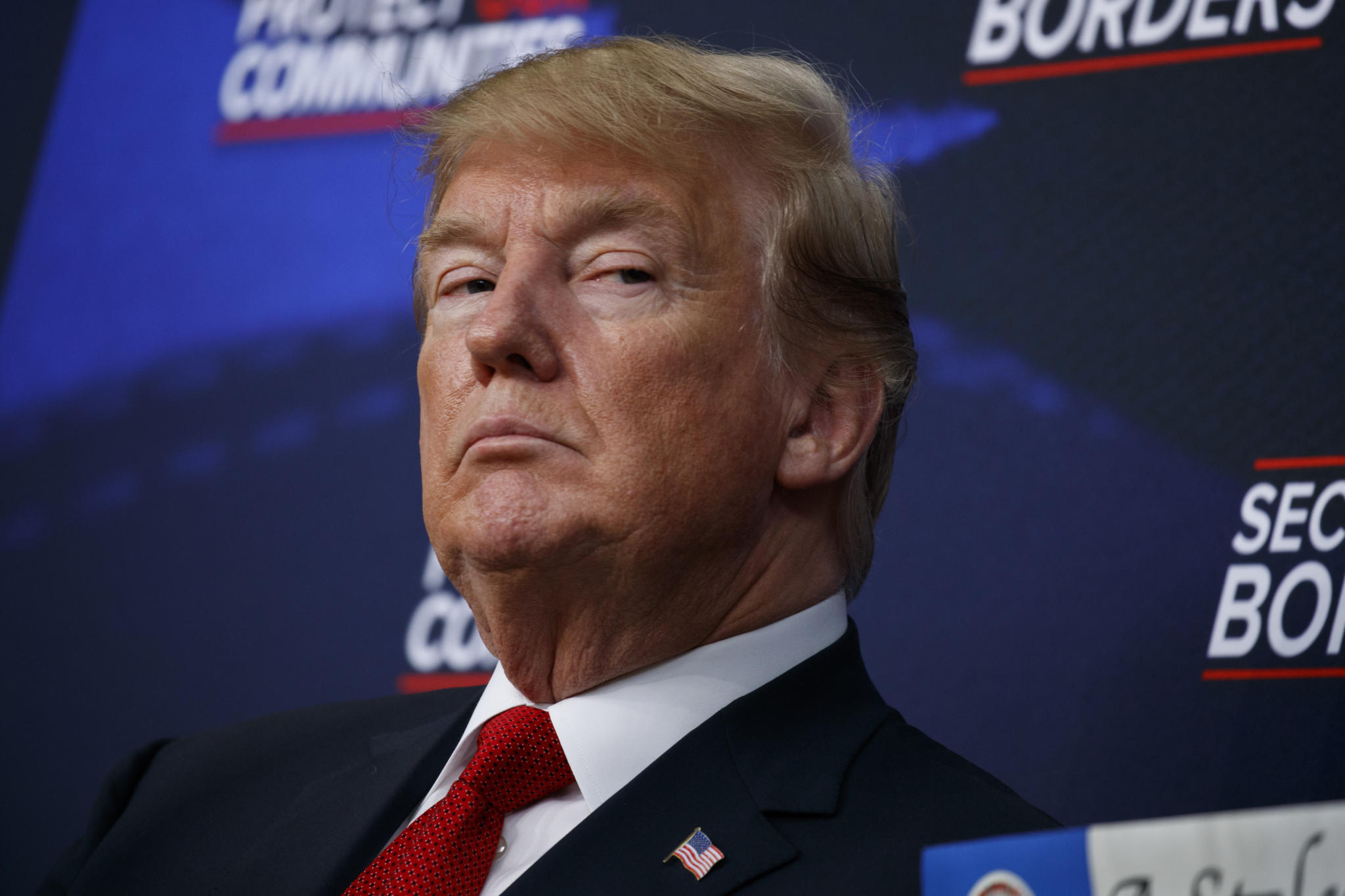 FILE - In this June 22, 2018 file photo, President Donald Trump listens during an event on immigration alongside family members affected by crime committed by undocumented immigrants, at the South Court Auditorium on the White House complex in Washington. Federal immigration and health officials were blindsided by President Donald Trump’s “zero tolerance” policy on migrants crossing the southwest border, triggering a cascade of problems as agencies struggled with the fallout from family separations, congressional investigators said in a critical report issued Wednesday. (AP Photo/Evan Vucci)